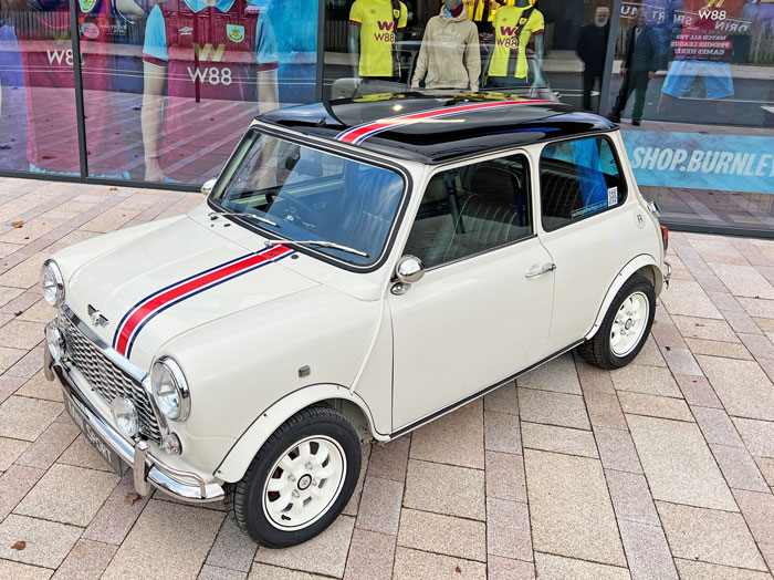 'Merlin' the Mini EV Conversion parked outside of the Burnley Football Club Stadium.